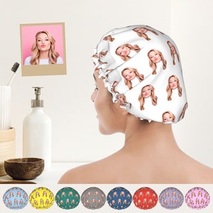 May include: A white shower cap with a repeating pattern of a woman's face. The shower cap is available in ten different colours: blue, yellow, green, grey, teal, red, purple, light blue, pink, and white.