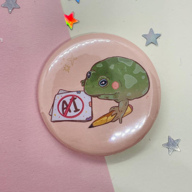 May include: A pink button with a green frog holding a pencil and a paper with a red circle and the text "A1" with a line through it.