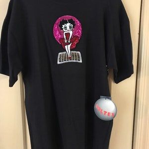 Betty Boop sequined and beaded on a black tee shirt imitating Marilyn Monroe in classic “7 Year Itch” movie.