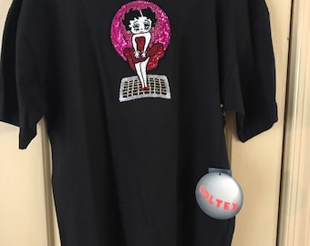 Betty Boop sequined and beaded on a black tee shirt imitating Marilyn Monroe in classic “7 Year Itch” movie.
