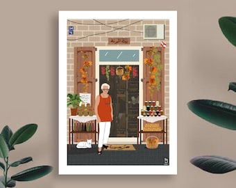 May include: A woman stands in front of a small shop with a sign that reads "Beit Al-Zayt" in Arabic. The shop is decorated with fall foliage and has jars of preserved goods on display. A white cat sits on the ground in front of the shop.