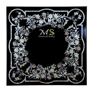 May include: Black square table top with a decorative floral design made of mother of pearl inlay. The design is a border around the edge of the table top. The center of the table top is black. The text "MS Handicraft Gallery" is in the center of the table top.