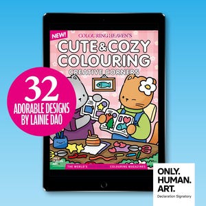 May include: A tablet displays a coloring book cover titled "Cute & Cozy Colouring" with the text "32 Adorable Designs by Lainie Dao." The cover features cartoon characters and creative corners. A pink circle highlights the number 32. The background is light blue.
