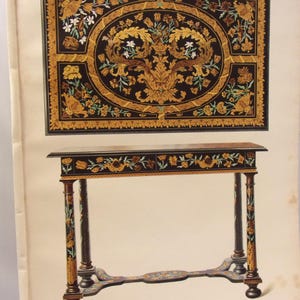 May include: An illustration of a decorative table and a rectangular wall hanging. The table has a black top with floral designs and ornate legs. The wall hanging features a black background with a central oval design and floral accents in gold, brown, and white.