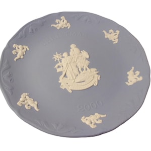 May include: A blue and white ceramic Christmas plate with a depiction of the three wise men and the text "Christmas 2000".