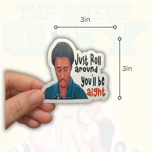 May include: A die-cut sticker featuring a portrait of a person with dark hair wearing a blue jacket. The text reads "Just Roll around you'll be aight" in black and red lettering. The sticker measures 3 inches by 3 inches as shown in the image.