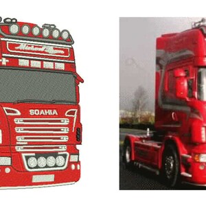 May include: Red semi-truck with gray accents and the text "Michael Ryder" above the windshield. The truck has multiple lights on the roof and front bumper. The word "SOAHA" is visible on the front.