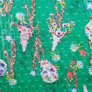 Cotton poplin with silk mix Skulls with flowers pattern on grass green base