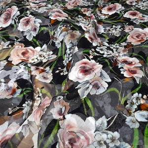May include: Black sheer fabric with a floral print featuring pink, white and green roses. The fabric has a textured, velvet-like surface.