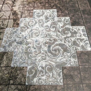 May include: A white, decorative, patterned tile with a swirling design. The tile is made of clear acrylic and is designed to be used as a floor covering.