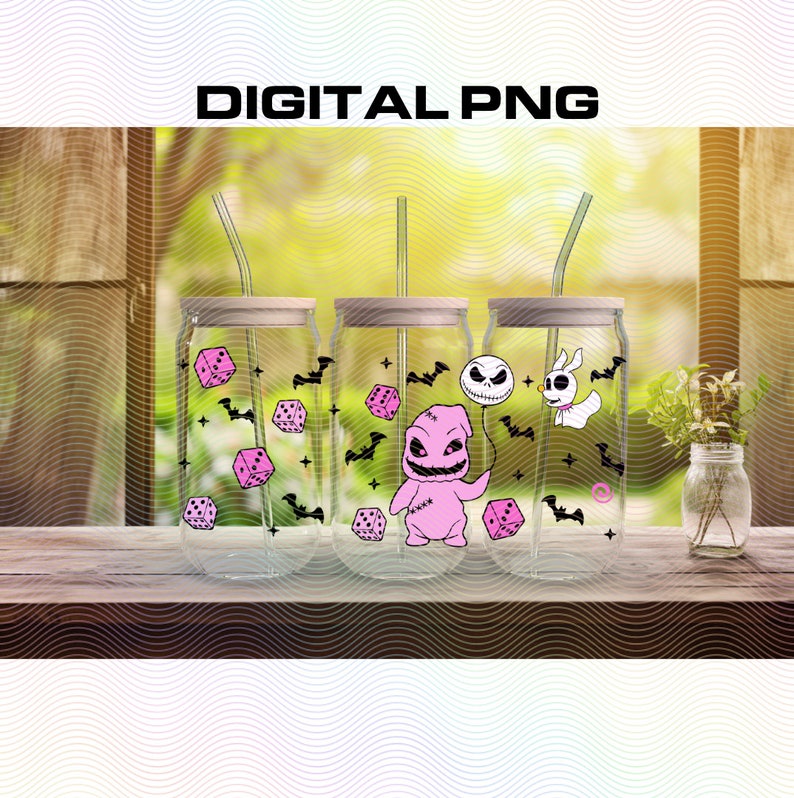 May include: Three clear glass tumblers with lids and straws, decorated with pink dice, bats, and characters from the Nightmare Before Christmas. The tumblers are on a wooden surface.