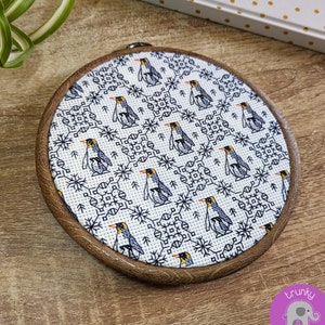 Penguin cross stitch and blackwork pattern | Mother and baby Emperor penguins with repeating winter snowflake motifs | Christmas black work