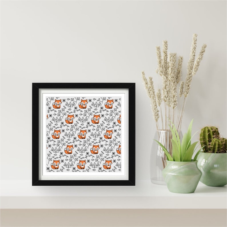 May include: A black framed print with a white background and a repeating pattern of orange foxes, black trees, and black vines.