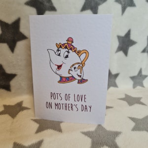 May include: A white card featuring a cartoon illustration of Mrs. Potts and Chip from Beauty and the Beast. The text on the card reads "Pots of love on Mother's Day."