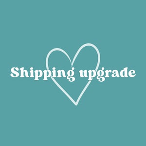 May include: A teal background with a white heart outline and the words "Shipping upgrade" in white, centered in the image. The text is in a sans-serif font.