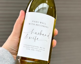 May include: A white wine bottle with a personalized label that reads "Pairs well with becoming husband & wife. Congratulations, we are so happy for you! Lots of love, Sam & Tom X."