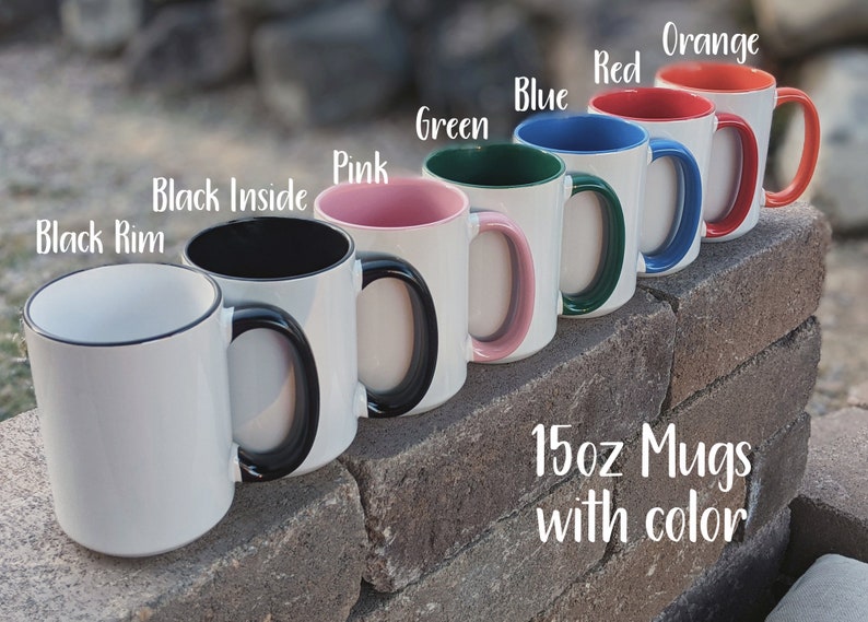 May include: Seven 15oz mugs with different colored rims. The mugs are white with black handles. The colors of the rims are black, pink, green, blue, red, and orange. The text "15oz Mugs with color" is written below the mugs.