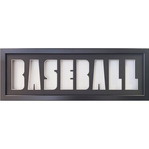 May include: Black framed shadow box with the word "BASEBALL" cut out in white.