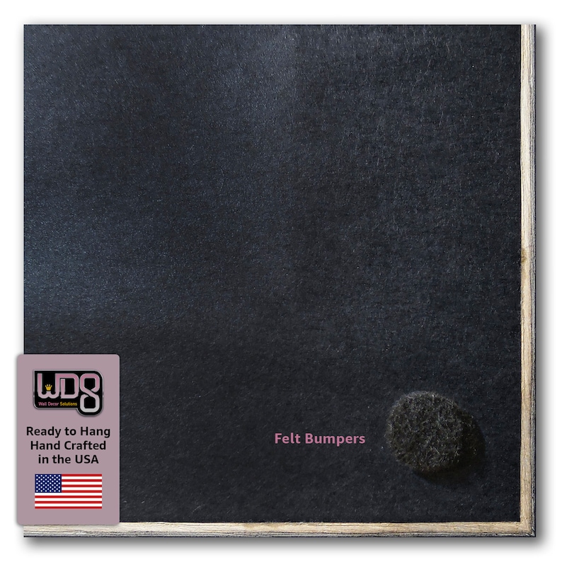 May include: A black chalkboard with a wood frame. The chalkboard has a white label with the text "Ready to Hang Hand Crafted in the USA" and an American flag. The chalkboard also has a black felt bumper on the bottom right corner. The text "Felt Bumpers" is printed in pink below the bumper.