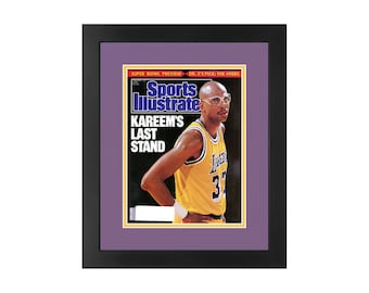 May include: A vintage Sports Illustrated magazine cover featuring Kareem Abdul-Jabbar in a yellow Los Angeles Lakers jersey with the text "KAREEM'S LAST STAND" on the cover.