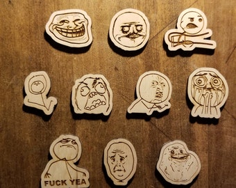 May include: A set of 10 wooden meme magnets featuring popular internet memes, including Trollface, Success Kid, and Forever Alone. Each magnet is approximately 2 inches in diameter and features a laser-engraved design.