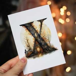 May include: A watercolor illustration of the letter X, stylized as a house in a forest with a full moon in the background. The house has a window with a warm glow and a door. The forest is depicted with dark brown trees and orange leaves.