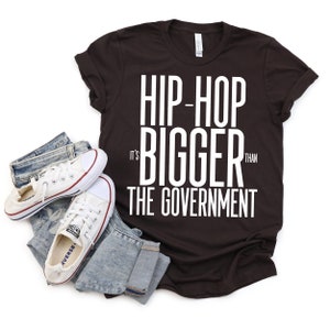 Hip Hop It's Bigger than the Government Nostalgic Hip-Hop Lyric Design on Black Short Sleeve and Long Sleeve Tops, Rap Lyric Tribute Art