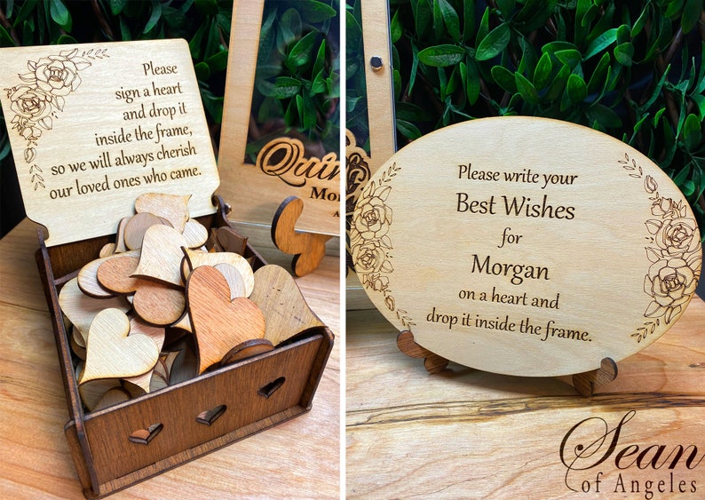 May include: Wooden guest book alternative with a box of heart-shaped wooden pieces and a sign that reads "Please sign a heart and drop it inside the frame." Another sign says "Best Wishes for Morgan."