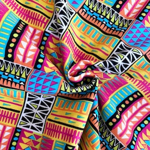 May include: Vibrant fabric with a geometric pattern in pink, yellow, orange, blue, and black. The design features a patchwork of shapes, including triangles, rectangles, and lines, creating a bold and colorful textile.