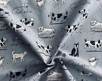 グレーの43インチ幅に白黒の犬が描かれた100%コットンのノベルティ生地 - ファットクォーター、ハーフヤード+ヤード単位で販売