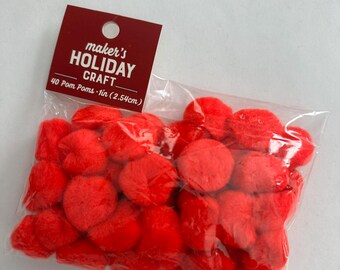 May include: A bag of 40 red pom-poms, each measuring 1 inch (2.54 cm) in diameter. The bag is labeled "maker's HOLIDAY CRAFT".