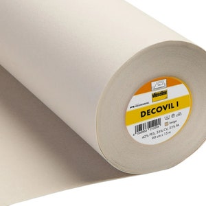 May include: A roll of beige Decovil I fabric. The label shows the brand Vlieseline and the fabric composition: 42% PES, 35% CV, 23% PA. The roll is 90 cm wide and 15 m long.
