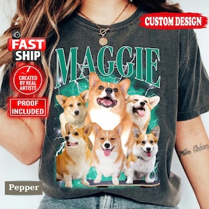 May include: Dark gray t-shirt featuring a graphic of six corgi dogs with the name "MAGGIE" in teal, outlined in white. The design includes lightning bolts and the words "CUSTOM DESIGN", "FAST SHIP", "CREATED BY REAL ARTISTS", and "PROOF INCLUDED".