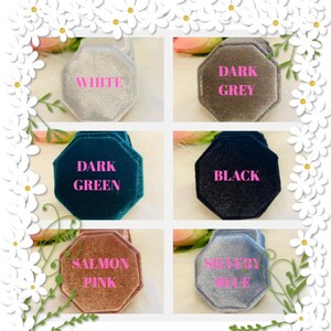 May include: Six octagonal velvet ring boxes in white, dark grey, dark green, black, salmon pink, and silvery blue. Each box features a soft, textured finish and is labeled with its corresponding color in pink text centered on the lid.