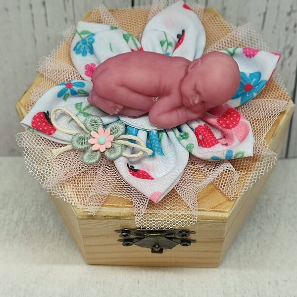 Wood box with mini silicone baby doll now you can book a virtual visit to our nursery