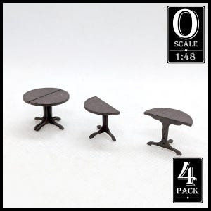 May include: Three miniature brown tables with detailed legs. One is round, one is half-round, and one is a rounded rectangle. The image includes a label that says "O SCALE 1:48" and another label that says "4 PACK".