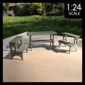 May include: Miniature green wooden outdoor furniture set, including a table and two benches. The set is painted in a muted green color and features a slatted design. The image includes the text "1:24 SCALE".