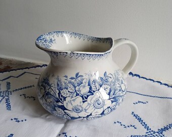 Old pitcher in earthenware from Lunéville (half porcelain) blue flowers