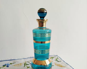 Large vintage turquoise blue and gold glass bottle