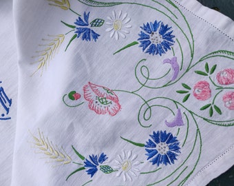 Vintage French tea tablecloth or centerpiece embroidered with bouquets of flowers on linen.