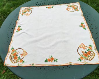 Hand-embroidered linen tea tablecloth or centerpiece with flower baskets