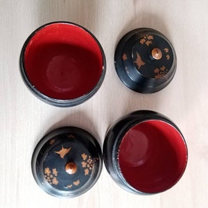 Antique tea boxes in black lacquered wood with Asian decoration.