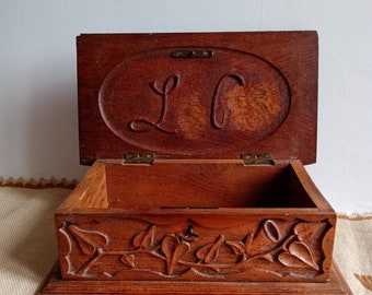 Black Forest wood carved jewelry box with forest flower motifs