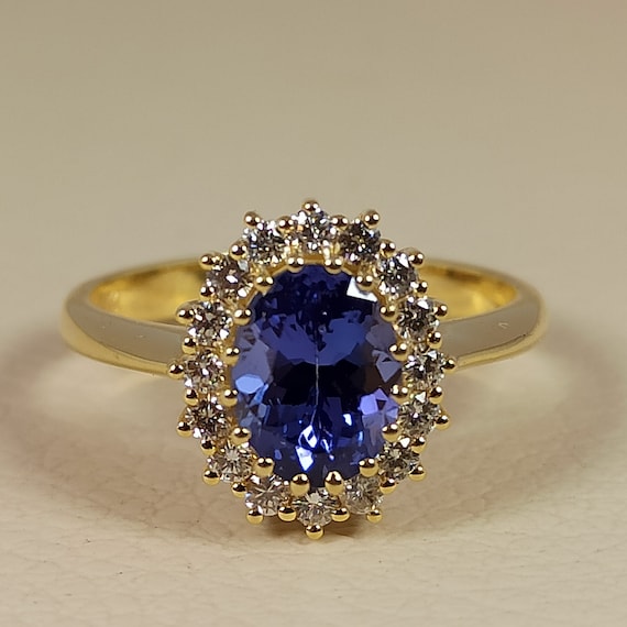 Rosette style engagement ring with tanzanite and full cut diamonds in 18 ct. yellow gold