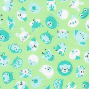 May include: A fabric with a repeating pattern of cartoon animal faces in shades of teal and white on a light green background. The animals include bears, rabbits, lions, and giraffes.