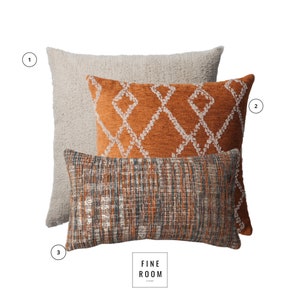May include: Three decorative throw pillows. The largest is a light beige, textured square pillow. The middle pillow is orange with a white diamond pattern. The bottom pillow is a rectangular shape with a woven pattern in shades of orange, gray, and blue.