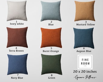 May include: Eight 20 x 20 inch square throw pillows in various colors, including ivory white, blue, mustard yellow, terra brown, burnt orange, Aegean blue, navy blue, and green. The pillows are made of a soft, textured fabric.