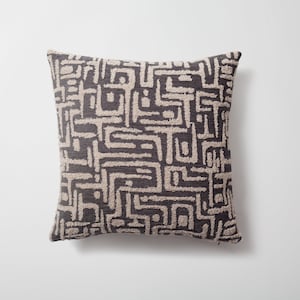 May include: A decorative throw pillow with a geometric pattern in beige and dark gray.