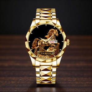 May include: A gold-toned wristwatch with a detailed horse sculpture on a black face. The watch features a gold band and a date display showing "SUN 8". The name "JAMES" is inscribed at the bottom of the watch face.