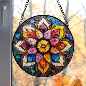 May include: A stained glass window hanging with a chain. The window is round and features a colorful mandala design with a central flower motif. The colors include red, orange, yellow, green, blue, purple, and pink.